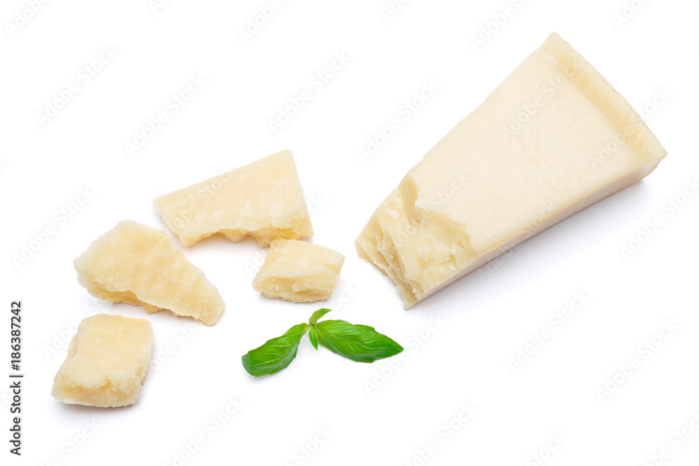 pieces of Parmesan cheese with basil on white background