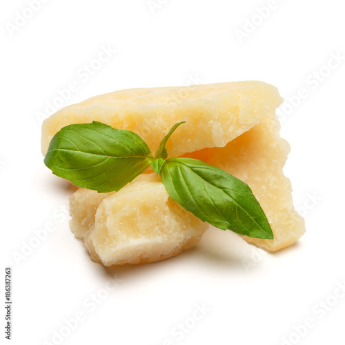 pieces of Parmesan cheese with basil on white background