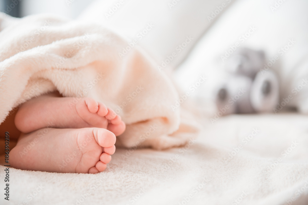 Close up of sweet newborn infant taking rest in apartment. Copy space in right side Close up of sweet newborn infant taking rest in apartment. Copy space in right side