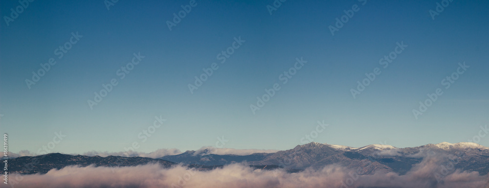 Panoramic picture of the morning fog around the mountains