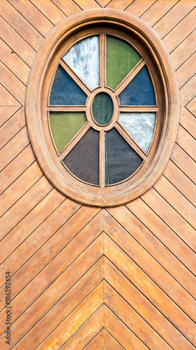 multi colored window in wooden door photo