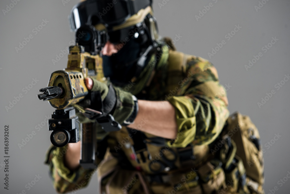 Fototapeta premium Close up male hands keeping assault carbine. Profession and army concept. Isolated