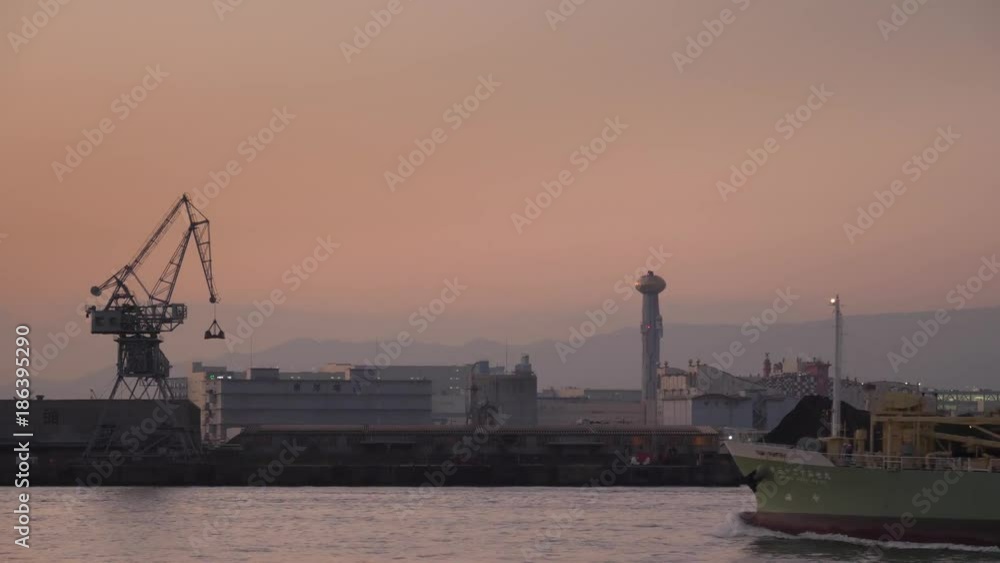 Cargo ships passing in port of Tokyo at sunset Cargo ships passing in port of Tokyo at sunset