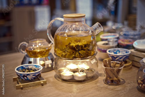 Blooming Flower Tea in Glass Tea Pot with traditional chinese accessories stay on the table in teashop