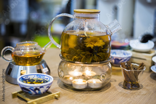 Blooming Flower Tea in Glass Tea Pot with traditional chinese accessories stay on the table in teashop