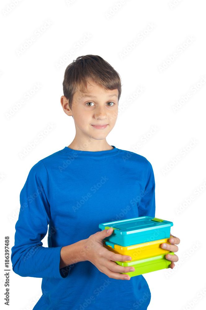 Boy in blue shirt holding colored lunch boxes. Isolated on white Boy in blue shirt holding colored lunch boxes. Isolated on white
