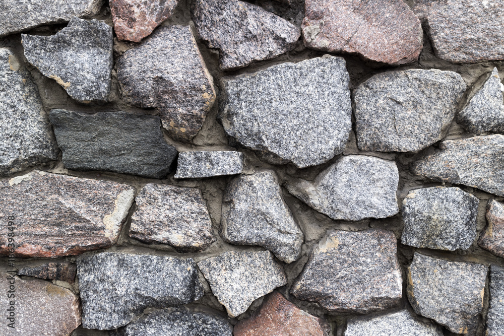 Rubble grey and brown stone wall, rubble work Rubble grey and brown stone wall, rubble work