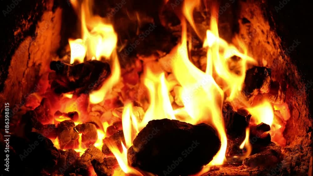 Burning coal and wood in a UK home Fireplace on a winters day. Burning coal and wood in a UK home Fireplace on a winters day.