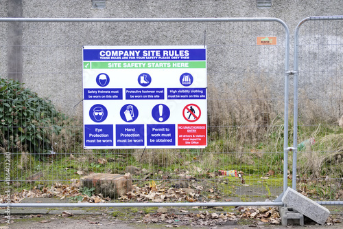 Building site rules health and safety sign on fence photo