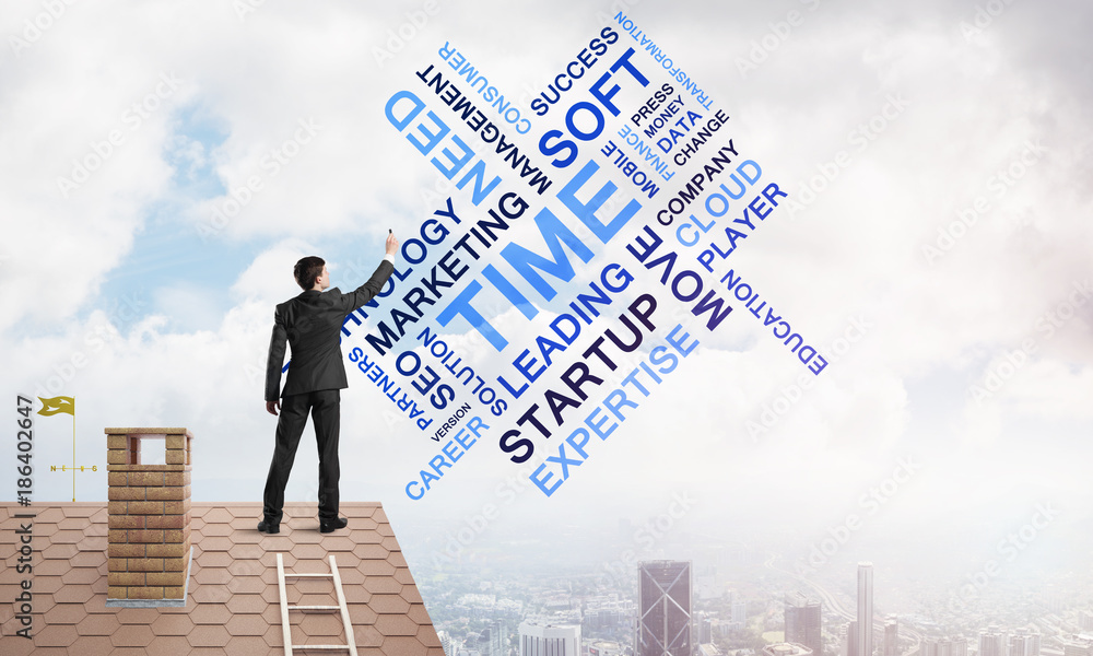 Young businessman standing on house roof and writing leadership skill concept. Mixed media Young businessman standing on house roof and writing leadership skill concept. Mixed media