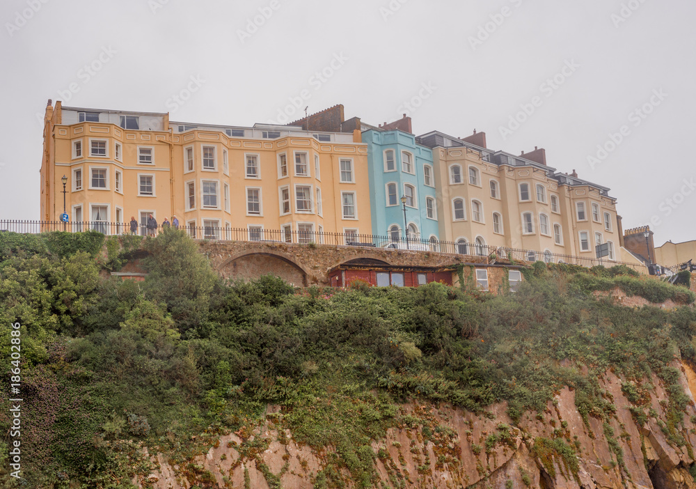Colourful houses perched high on the cliffs at Tenby south beach, Tenby, Wales, UK