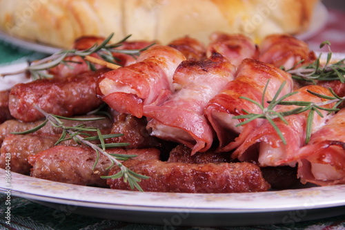 Chicken meat wrapped in bacon and cevapcici