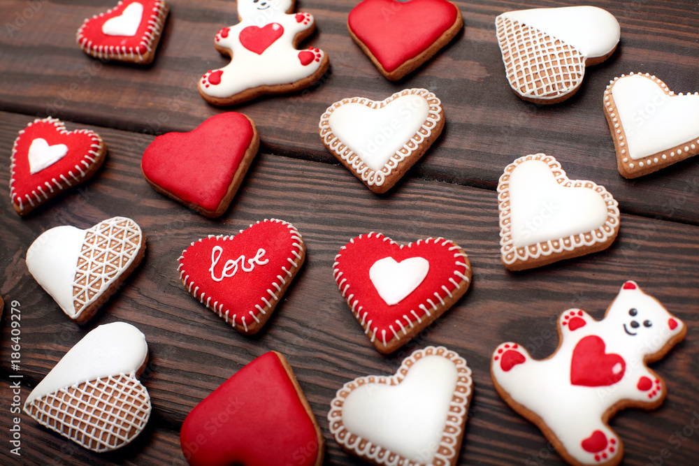 Heart-shaped biscuits for Valentine's Day. Gingerbread Valentine on wooden background Heart-shaped biscuits for Valentine's Day. Gingerbread Valentine on wooden background