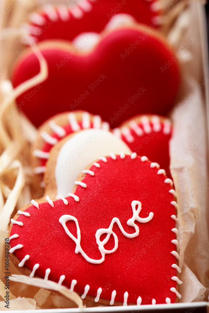 Red cookies hearts with white icing Love in white box .Gift for Valentine's Day.Valentine day background.Closeup Red cookies hearts with white icing Love in white box .Gift for Valentine's Day.Valentine day background.Closeup