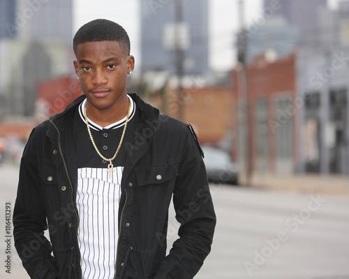 Street scene young African American male model against Dallas Texas skyline. photo