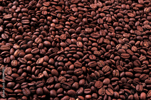 Coffee bean dark roasted scattered texture background photo
