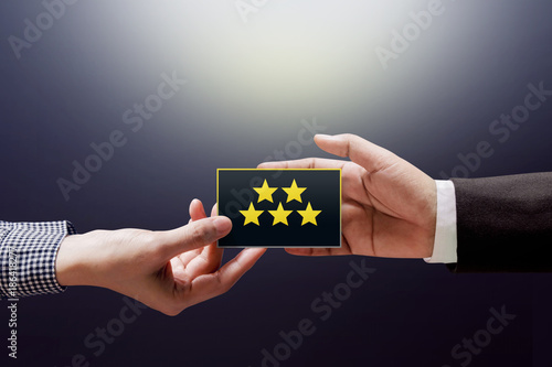 Customer Experience Concept, Happy Client Woman giving a Feedback with Five Star Rating on Card into a Hand of Businessman