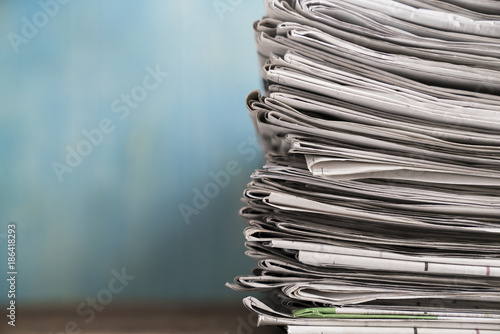 Принти на полотні close up newspapers folded and stacked background on the table