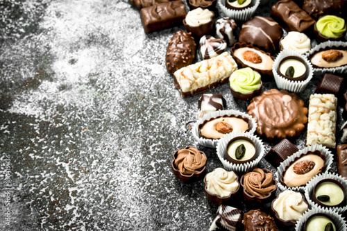 Chocolate candies. On rustic background.