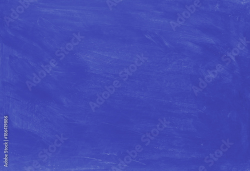Blue painted textured abstract background with brush strokes in gray and black shades.