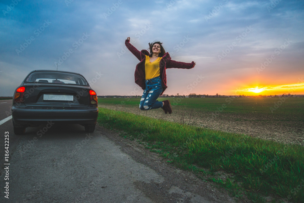 Fototapeta premium woman rests on sideroad at sunrise