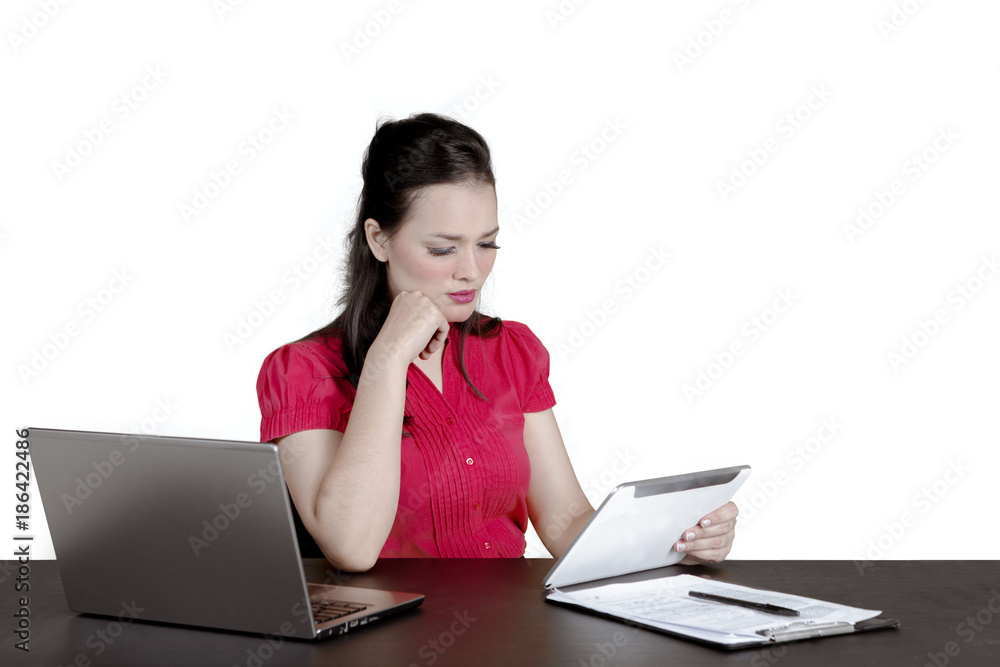Stressed businesswoman working with a tablet Stressed businesswoman working with a tablet