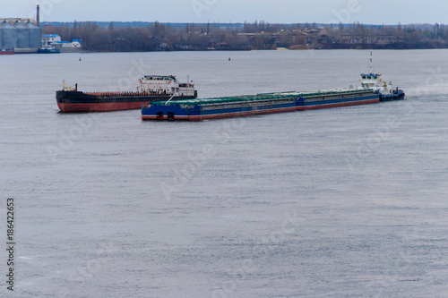 Cargo ship and barge sailing on the river Dnieper