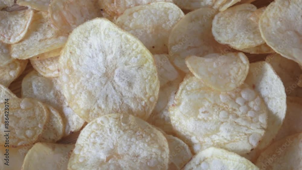 Salted potato chips on wooden background
Salted potato chips on wooden background