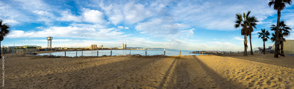 Beach of San Sebastia with the cable car tower of the port of Barcelona, Catalonia. Panoramic view