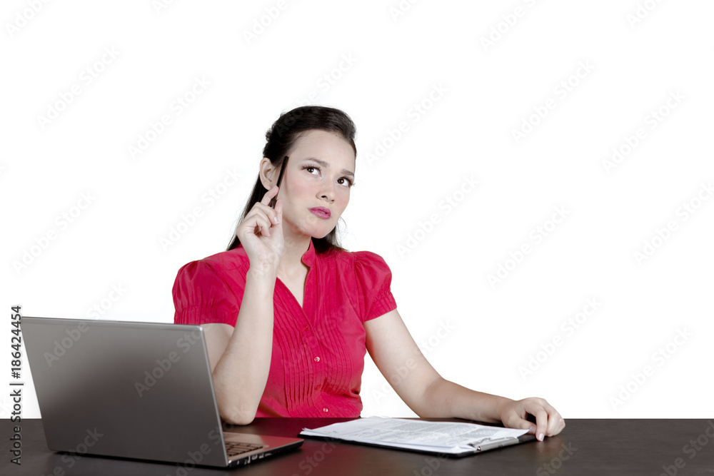 Caucasian businesswoman looks pensive on studio