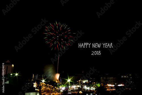 Blur image of New Year Eve Fireworks Display Show with word "happy new year" . soft focus,motion blur due to long exposure shoot. visible noise due to high ISO.