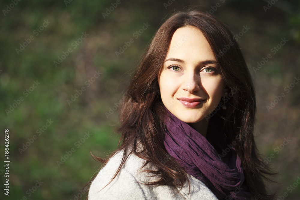 Fototapeta premium Portrait of a young beautiful woman in gray coat