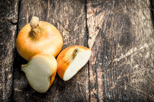Fresh onions. On wooden background.