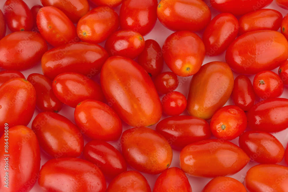 baby plum tomatoes. textured. closeup. color red. isolated on white background baby plum tomatoes. textured. closeup. color red. isolated on white background