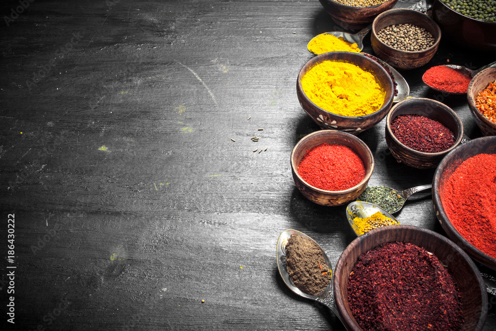 Ground spices in bowls and spoons. Ground spices in bowls and spoons.