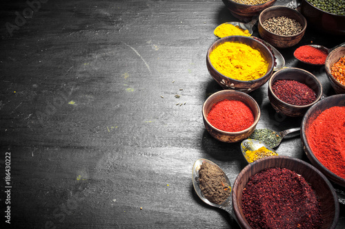 Ground spices in bowls and spoons.