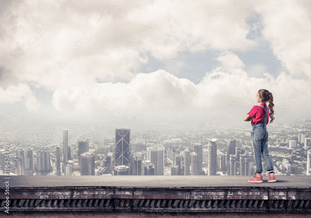 Concept of careless happy childhood with girl looking far away Concept of careless happy childhood with girl looking far away