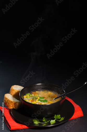 Vegetable soup in a black plate