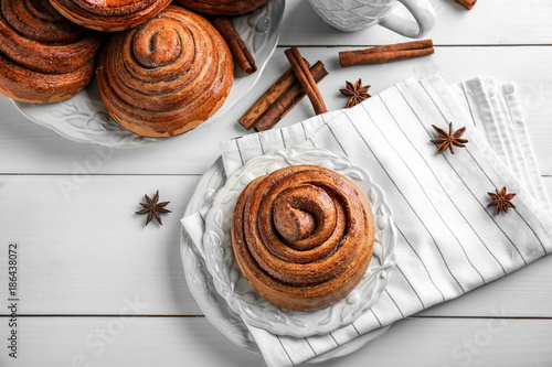 Composition with sweet cinnamon rolls on table