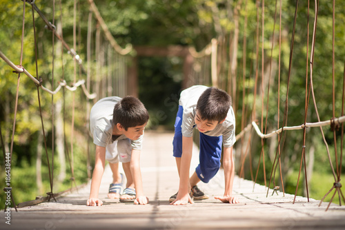 Little boy running together over the bridge outdoor activities