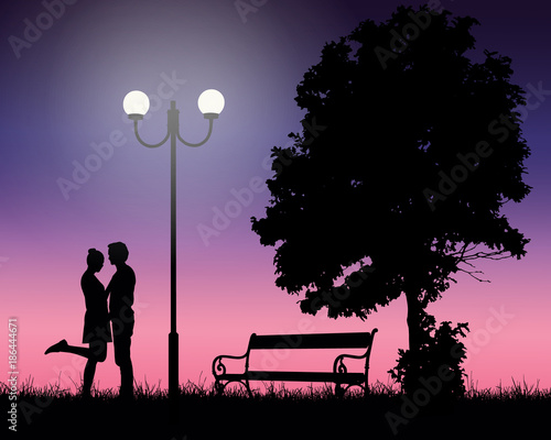 Two young lovers embracing under a tree and a shining lamp with pink sky, suitable as a card for valentine day