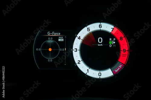 G force meter, tachometer and speedometer in sports car
