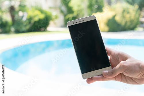 Female Stands Near By Pool at Summer Time Showing Smart Mobile Phone Bozcaada in Canakkale Turkey 2017