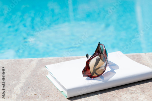 Book Sunglasses Near By Swimming Pool in Summer Time in Canakkale Turkey 2017