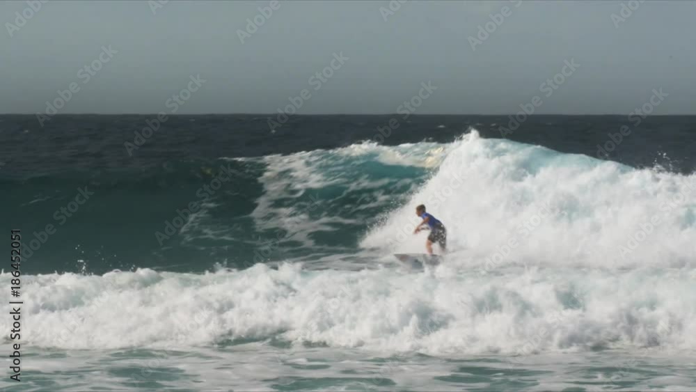 a surfer performs a series of cutbacks on a gold coast wave in queensland, australia a surfer performs a series of cutbacks on a gold coast wave in queensland, australia