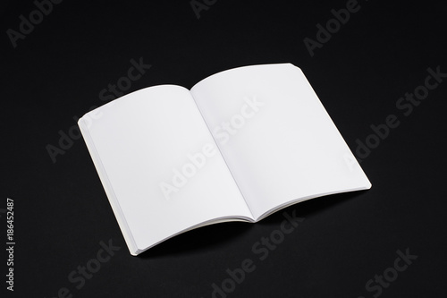 Mock-up magazine, book or catalog on black table. Blank page or notepad on solid background. Blank page or notepad for mockups or simulations.