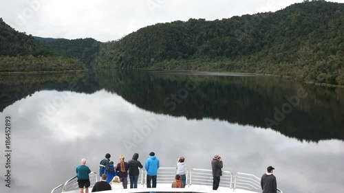 tourists on the bow of a boat enjoying a gordon river cruise in tasmania, australia photo