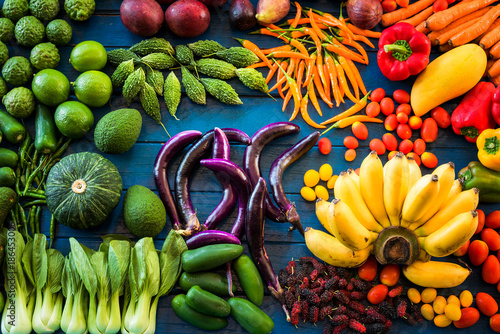 Fototapeta Naklejka Na Ścianę i Meble -  Flat lay of fresh  fruits and vegetables for background, Different fruits and vegetables for eating healthy, Colorful fruits and vegetables on blue plank