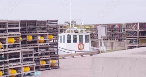 Fishing boat with lobster traps ready to get loaded on - static shot photo