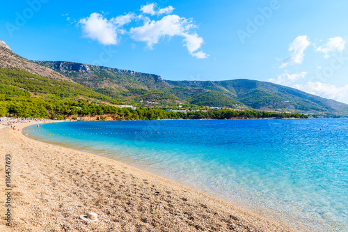 Fototapeta Naklejka Na Ścianę i Meble -  View of empty Zlatni Rat beach with beautiful sea water and mountains in background, Brac island, Croatia